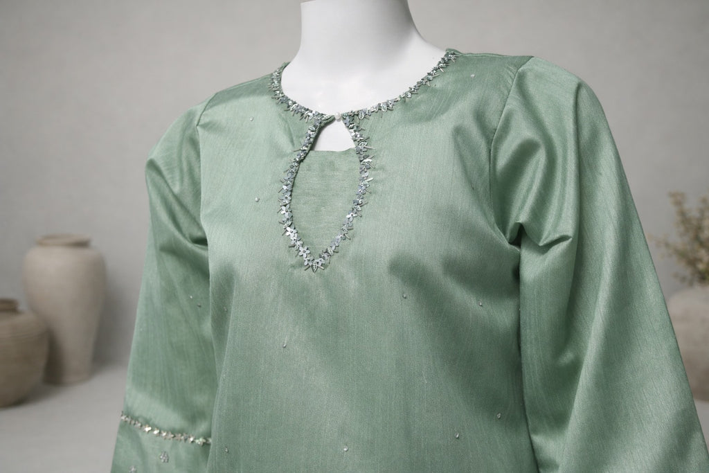 Close-up of embellished round neckline on mint green silk farshi shalwar kurta with delicate hand detailing