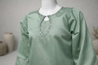 Close-up of embellished round neckline on mint green silk farshi shalwar kurta with delicate hand detailing