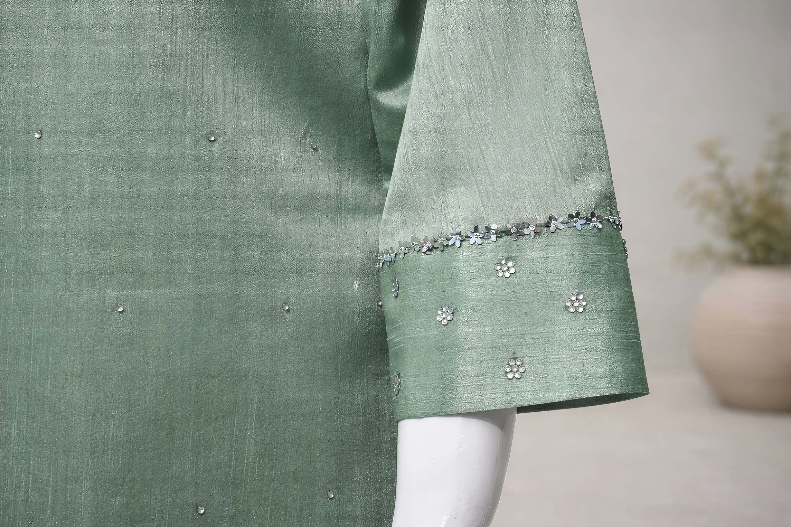 Three quarter sleeve detail with subtle embellishment on mint green silk farshi shalwar suit
