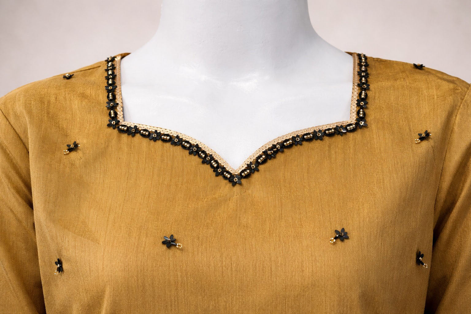 Mustard raw silk neckline close up with black bead and sequin embellishment
